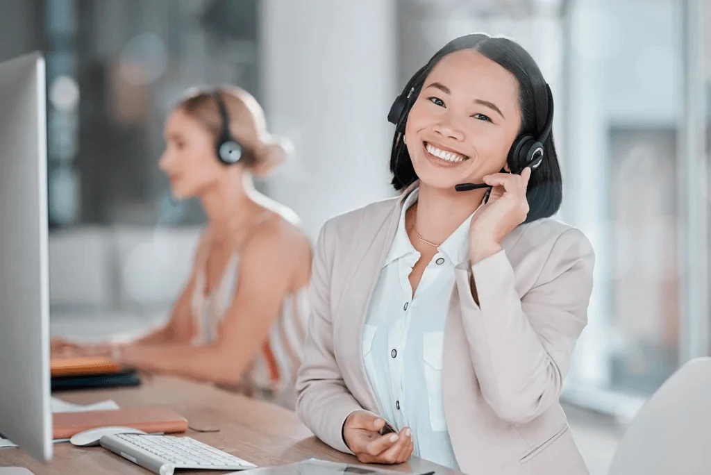 cheerful contact center agent in front of her computer