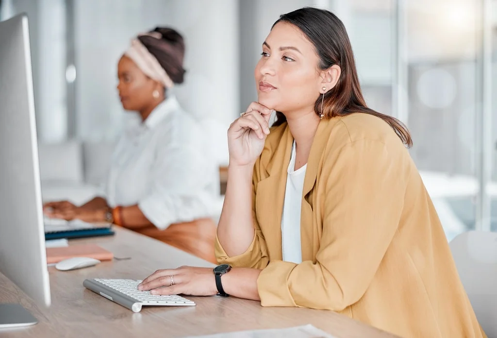 thinking computer and business woman typing