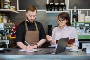 bookkeeper recording daily transactions for restaurant finances