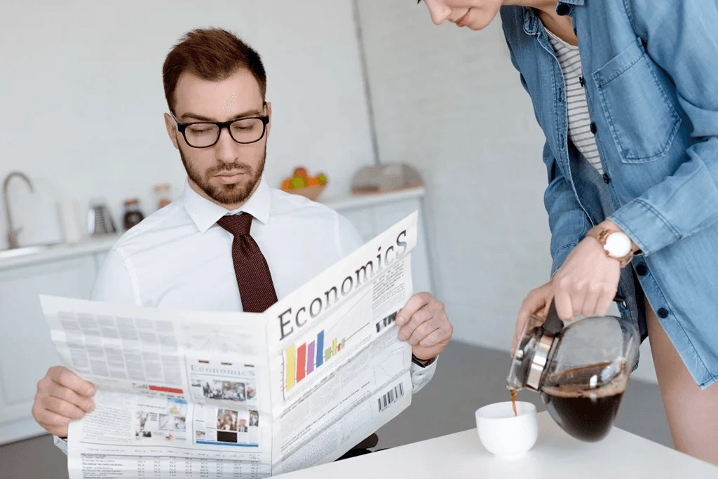 businessman reading a newspaper about economics