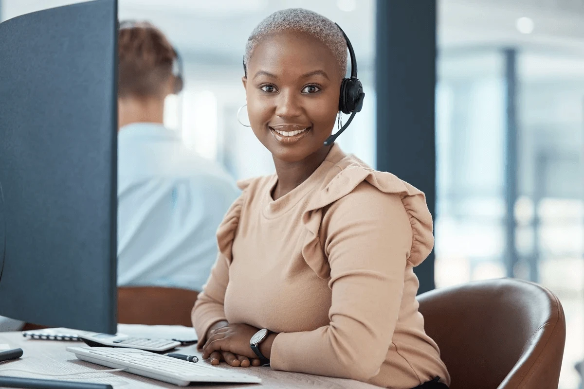 call center agent wearing a headphone and in front of a computer