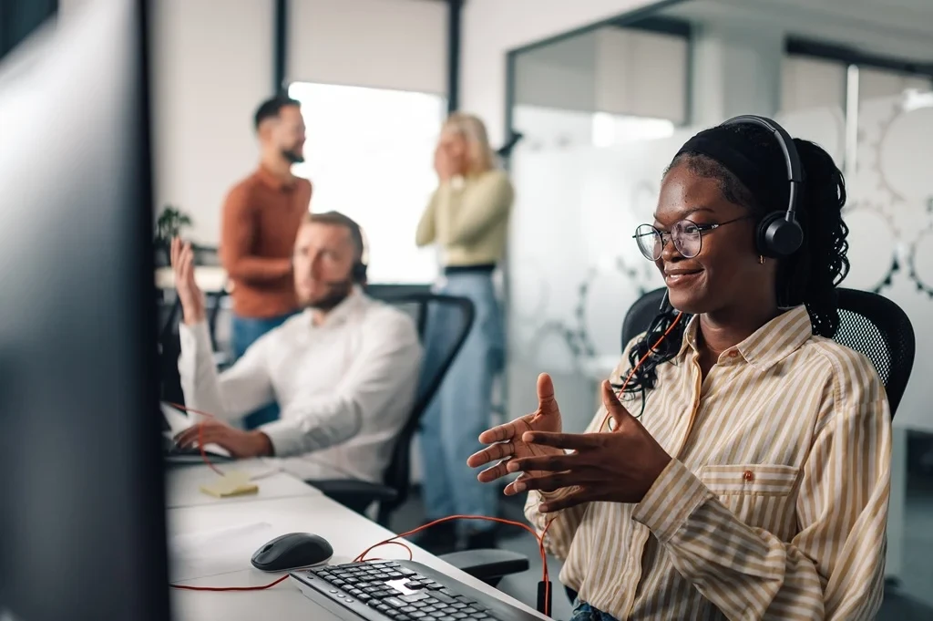 call center agents smiling despite high volumes of customer calls