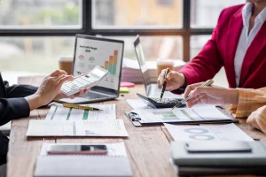 group of people analyzing graphs for bookkeeping