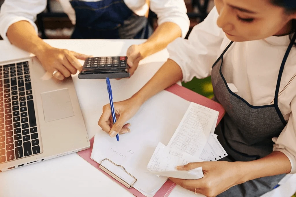 restaurant owners computing the sales for the day