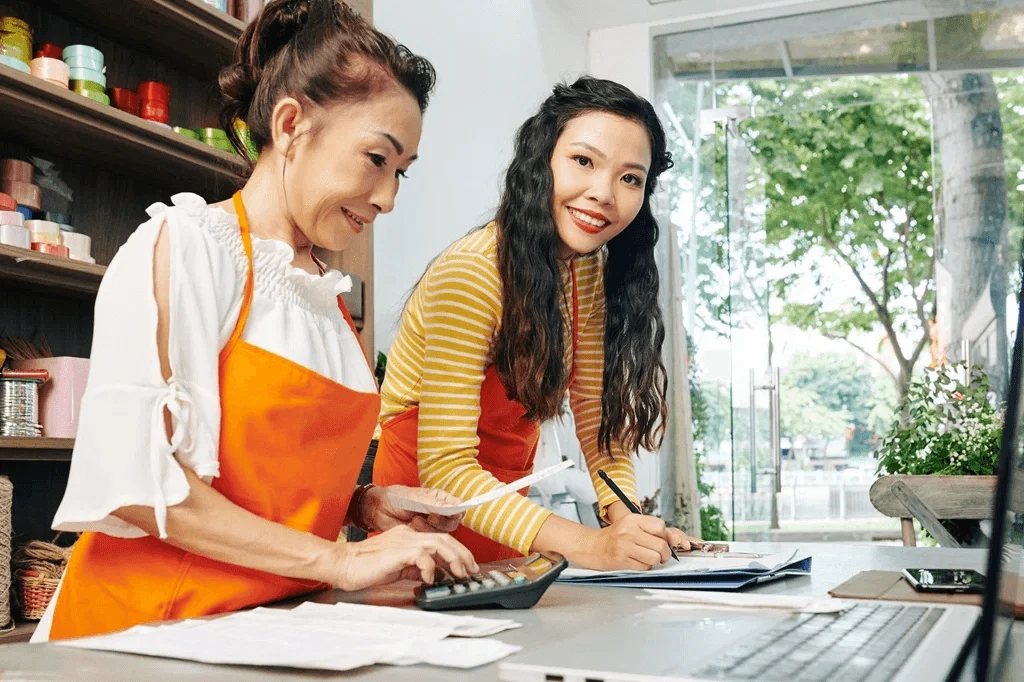 restaurant staff calculating daily sales for bookkeeping purposes