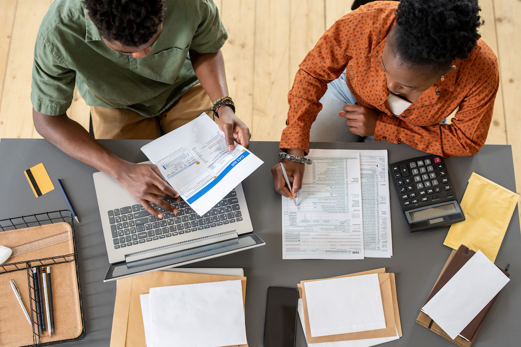 two-young-employees-focused-in-bookkeeping