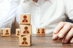 wooden blocks with symbols representing employees