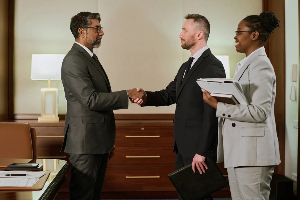 business owners shaking hands over a co-employment agreement