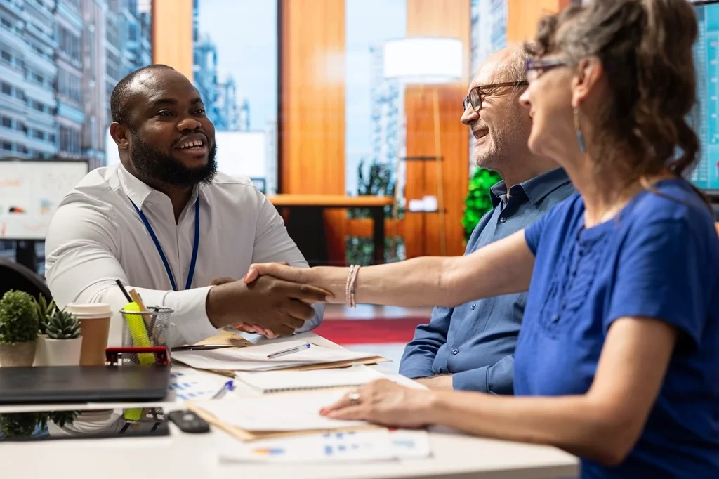 employee shaking the hands of an HR team