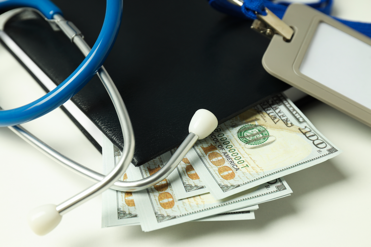 money with medical equipment concept of revenue cycle management