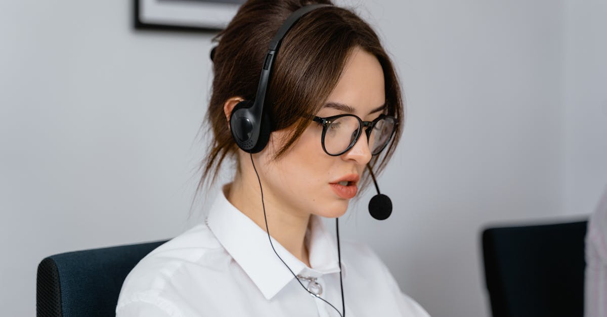 Focused woman working in a call center with a headset, providing customer support and communication services.