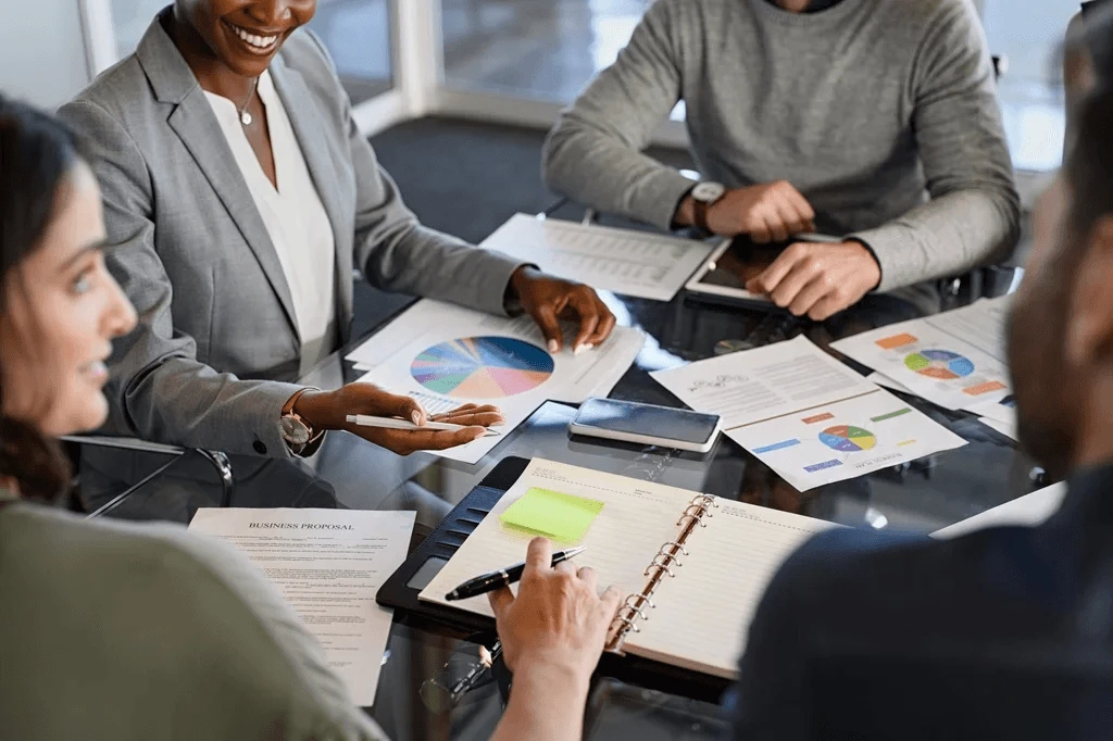 team of marketers discussing their monthly performance