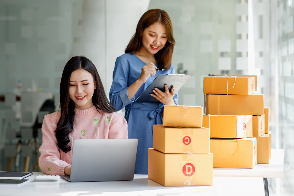 two-young-asian-women-managing-ecommerce-business