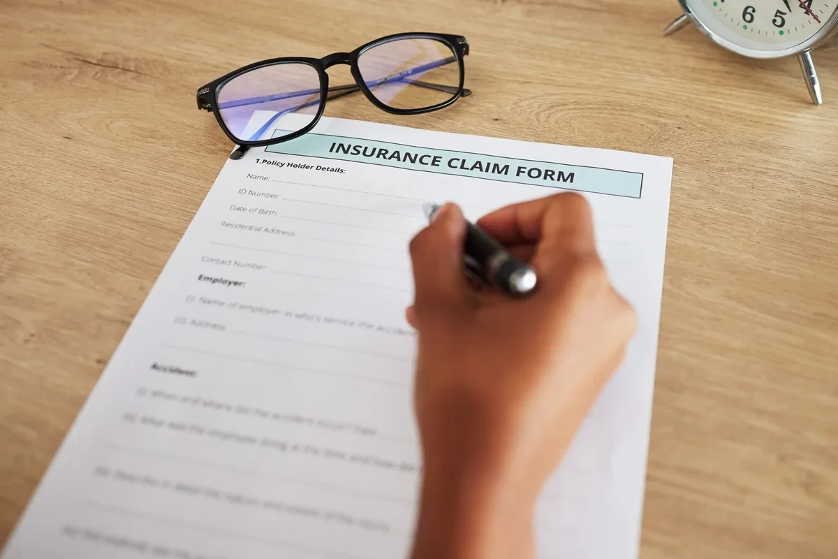 customer filling out an insurance claim form