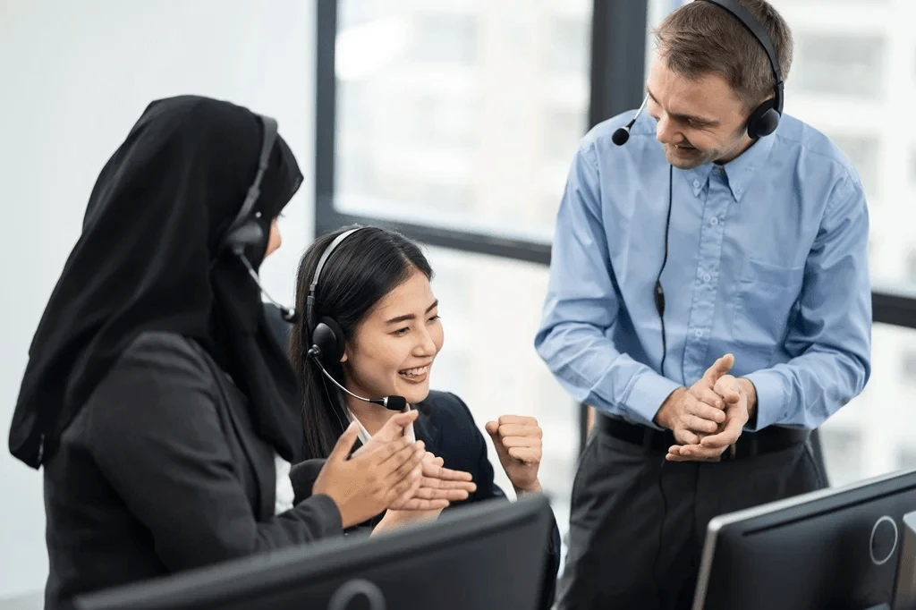 call center agents applauding their colleague for great customer service