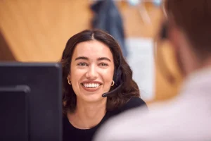 smiling customer service agent talking with a colleague