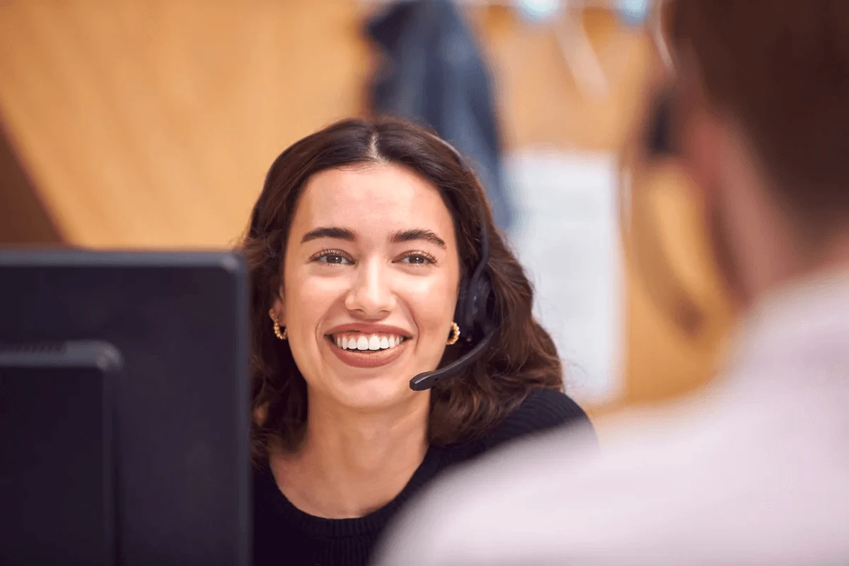 smiling customer service agent talking with a colleague