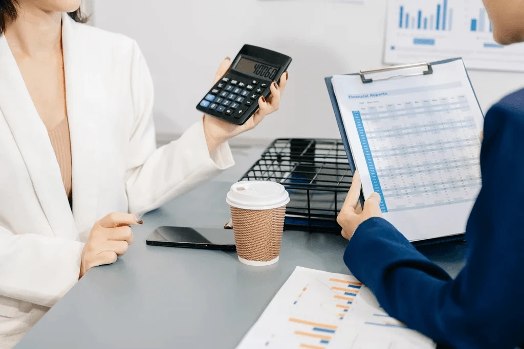CPA carefully verifying financial reports alongside the bookkeeper