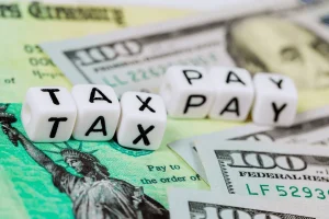 dice and dollars symbolizing tax paying