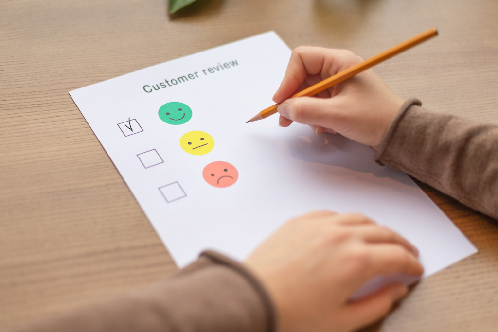 female ticking on customer happiness