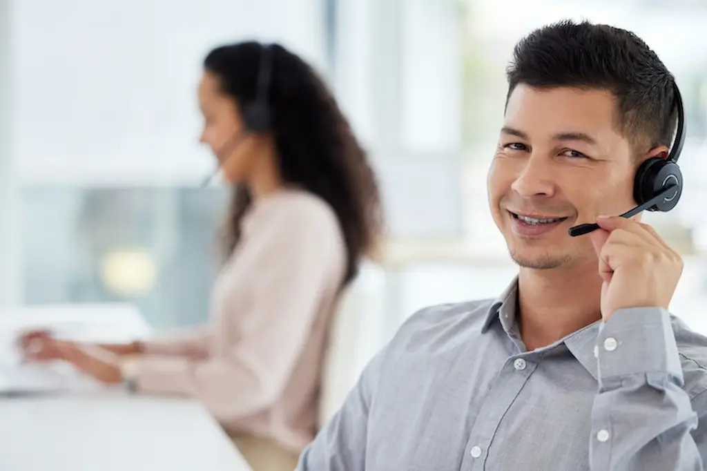 portrait of a young call centre agent working while smiling