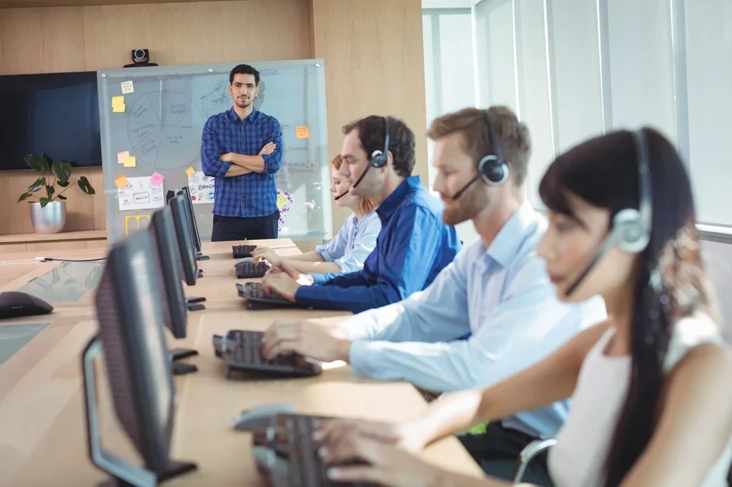 business owner supervising his customer service team