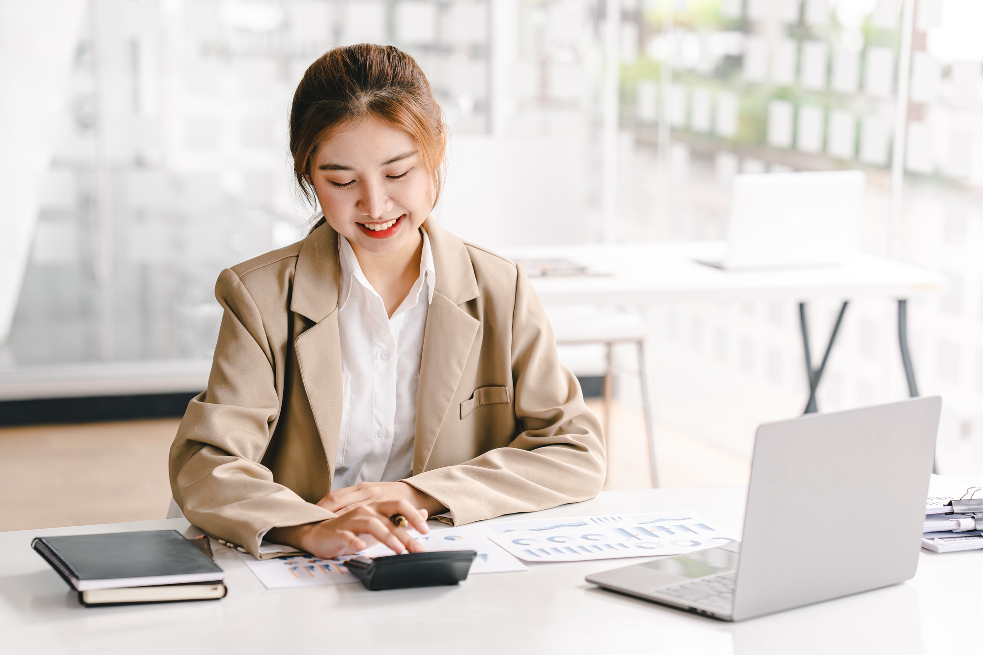 business woman or accountant who are using a calculator to calculate business data Accounting docume