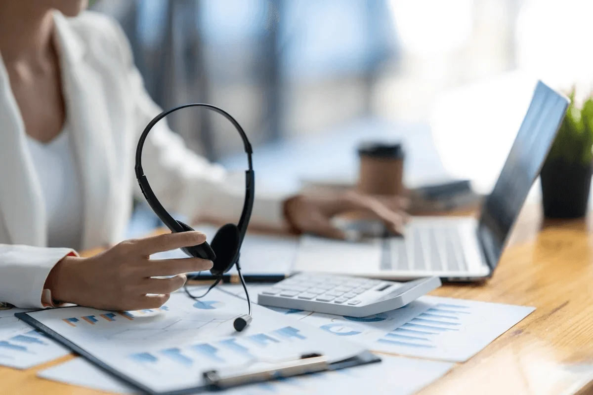 CPA with headset and calculator representing accounting outsourcing