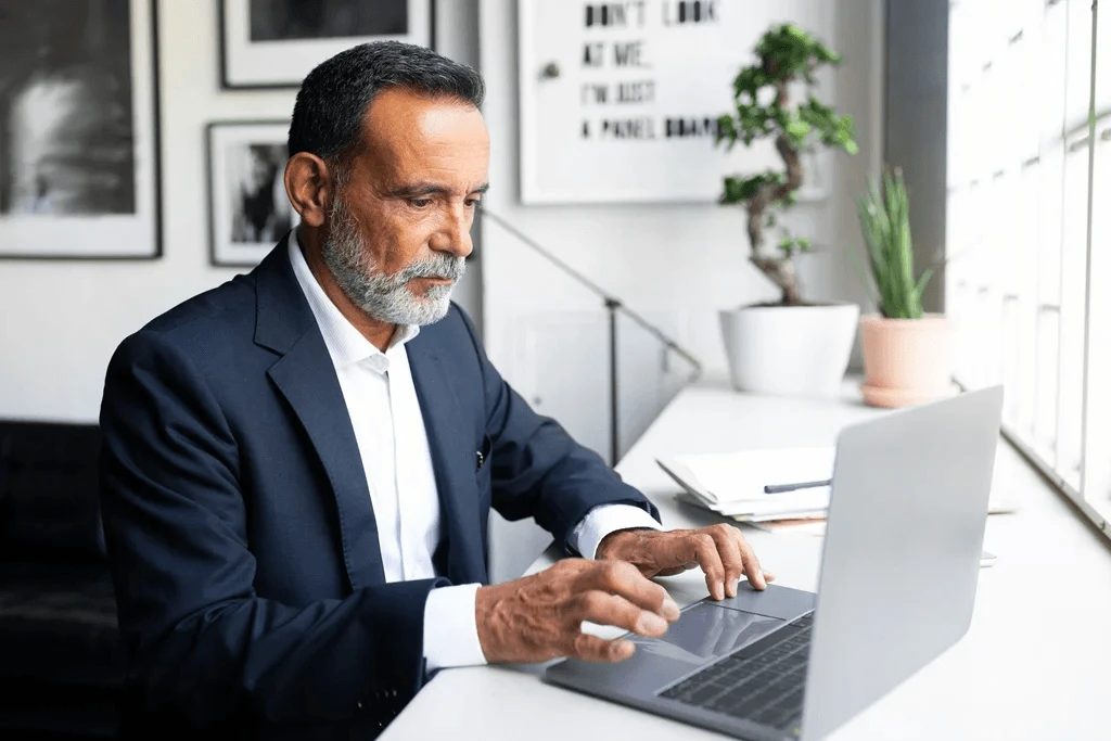 executive researching how outsourcing drives cost reduction