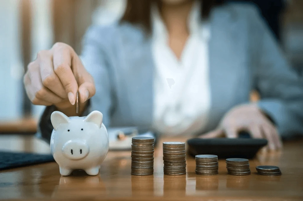 piggy bank and a few stacks of coins symbolizing company savings