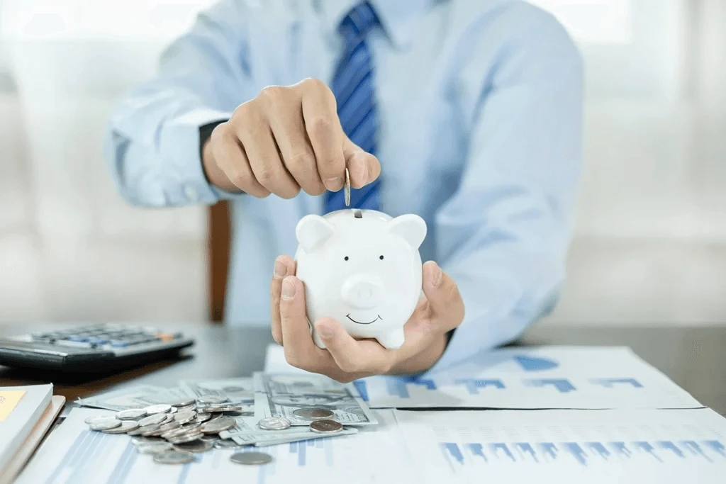 professional holding a piggy bank symbolizing company savings