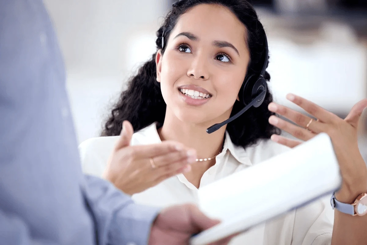 skilled customer service agent explaining her process to the team leader