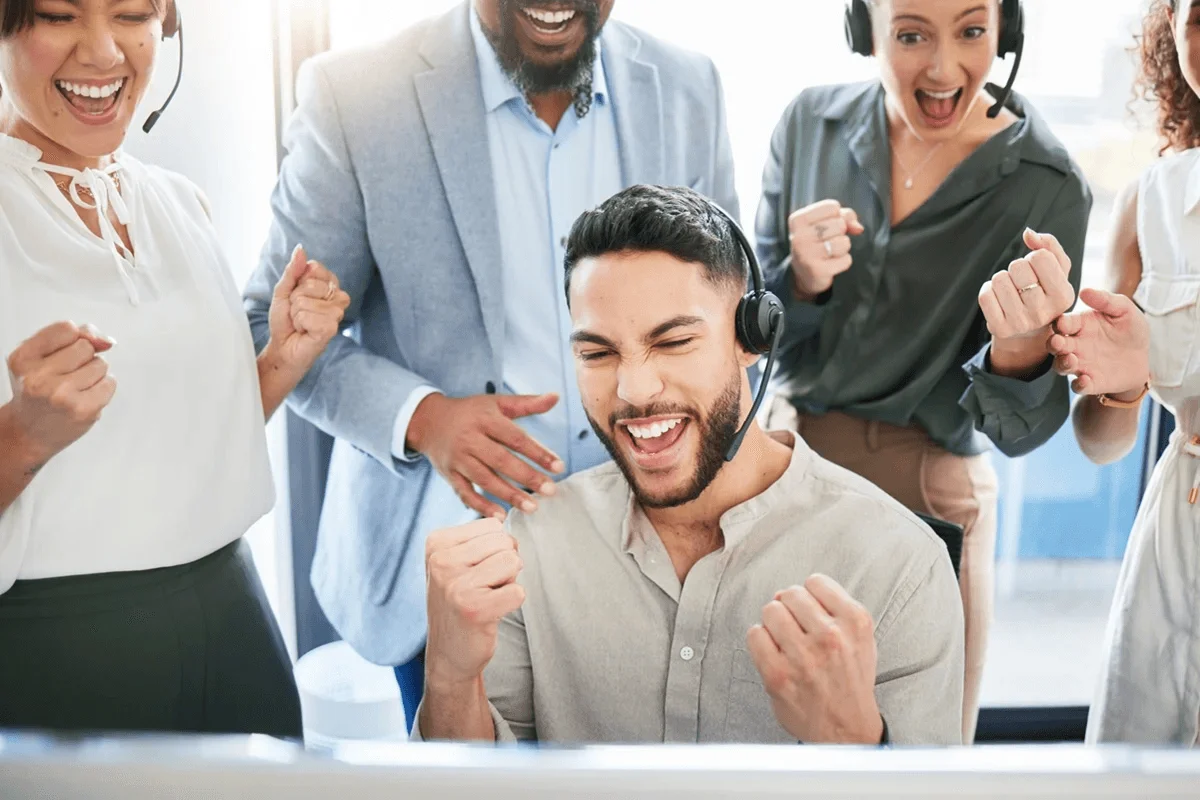 agents celebrating after reaching their customer service goals
