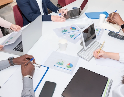 professionals comparing in-house costs versus outsourcing using an outsourcing cost calculator