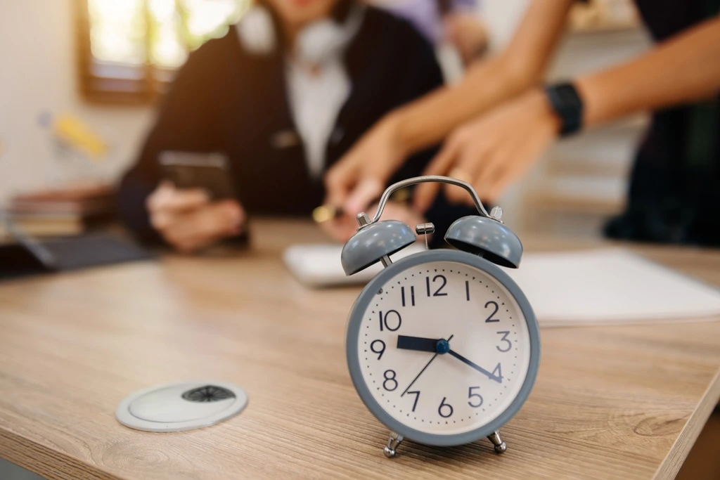 coworkers discussing the advantages of time zones in outsourcing