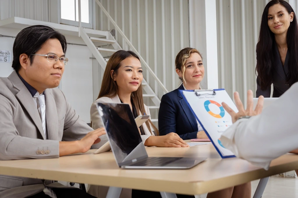 team meeting highlighting outsourcing human resources for small business growth