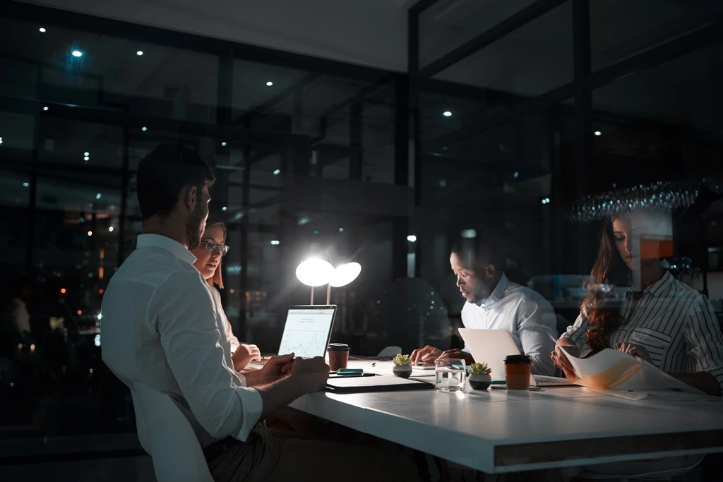 team working at night showcasing advantages of time zones in outsourcing