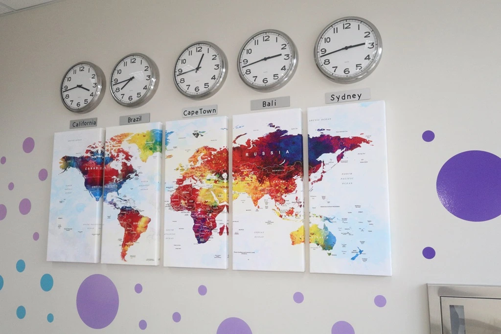 world map with clocks showing global times showing advantages of time zones in outsourcing