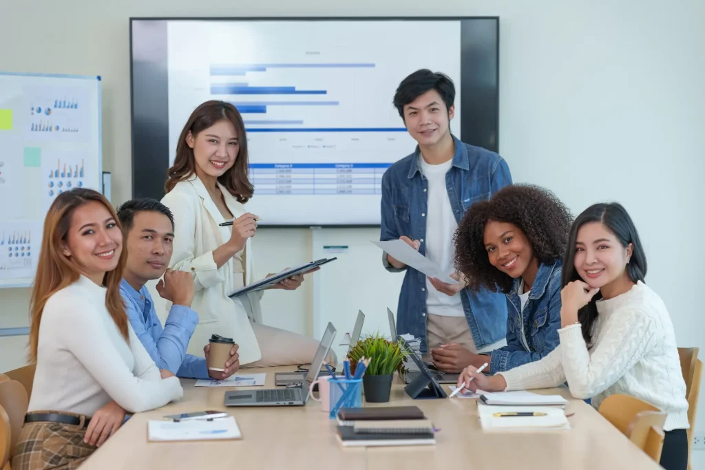 outsourcing team smiling during a team meeting