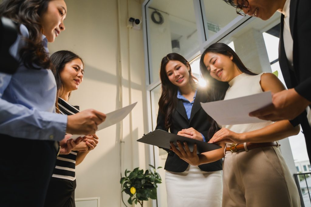 Outsource team reviewing documents during a meeting in the office