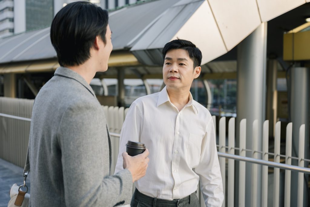 two professional discussing client retention