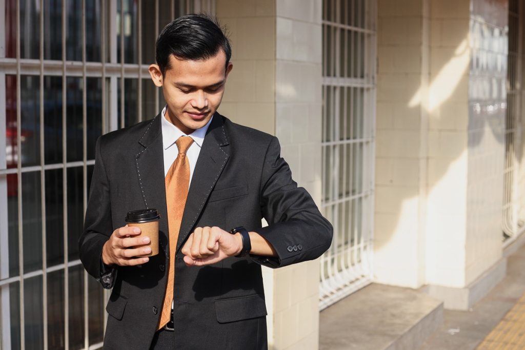 man looking at his watch to check time
