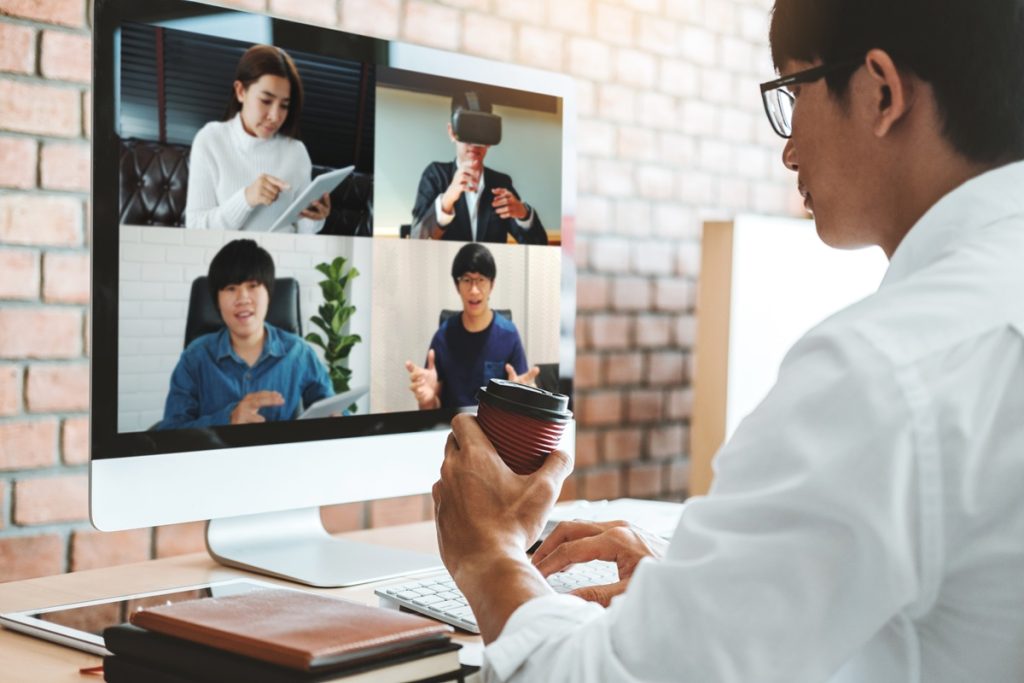 Asian man working from home use Smart working and video conference online meeting