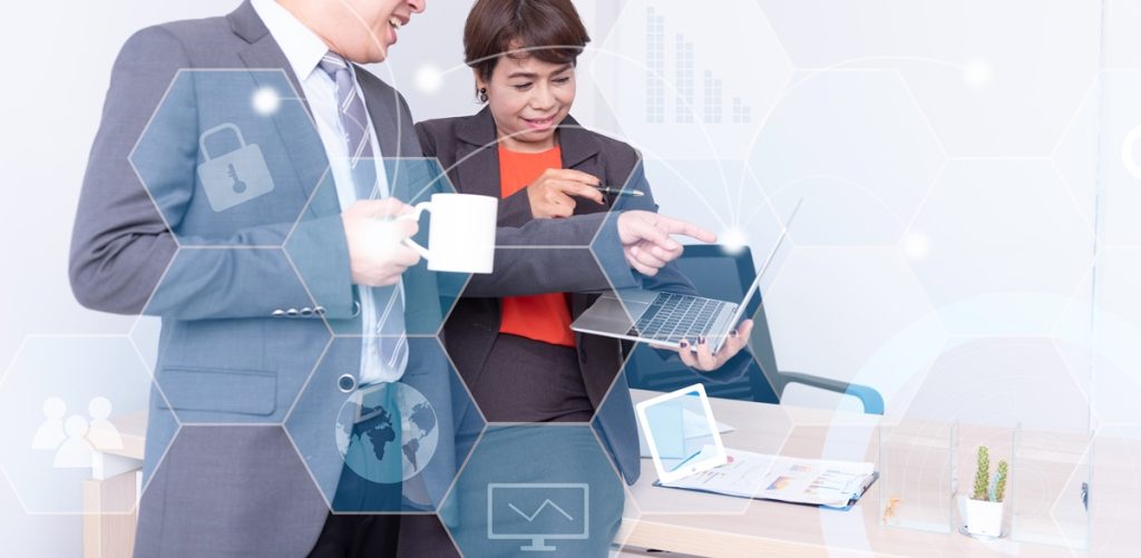 two professionals reviewing compliance-aware automation for company system