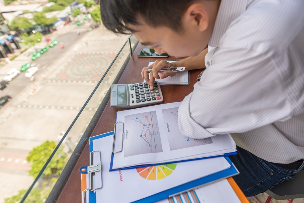 An outsourced bookkeeper checks the software accounting output for documentation