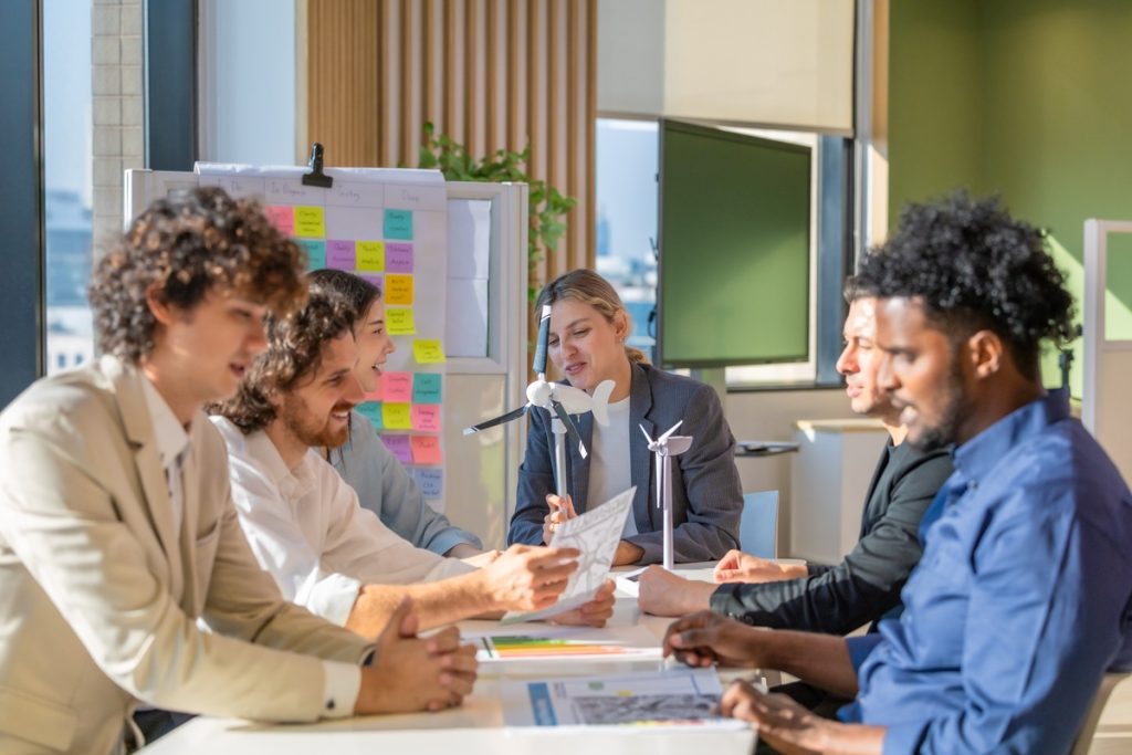 diverse team in the meeting for staff augmentation vs outsourcing strategy