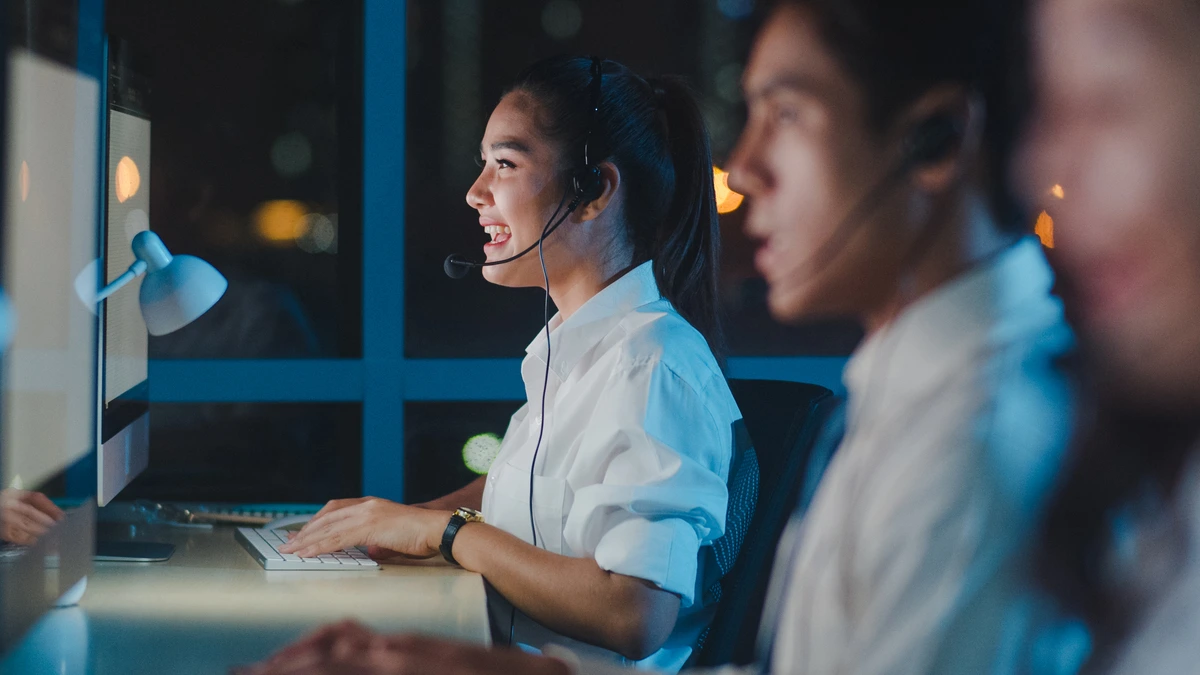 A scene where an Asian agent is seen building emotional connection in customer service.