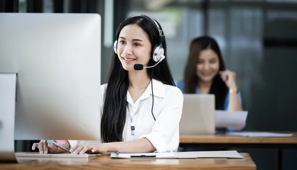 smiling asian female operator speaking with client 2026 03 16 00 41 57 utc 1 1