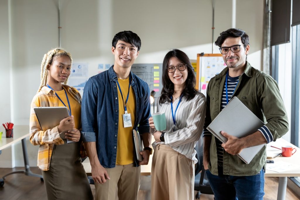 A team of gen z employees smiling