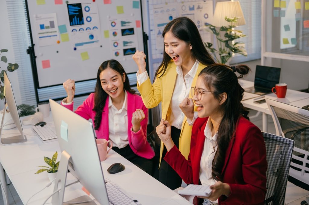 An SEO team celebrates their success after increase sessions on client's website